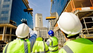 Four construction professionals observing a jobsite